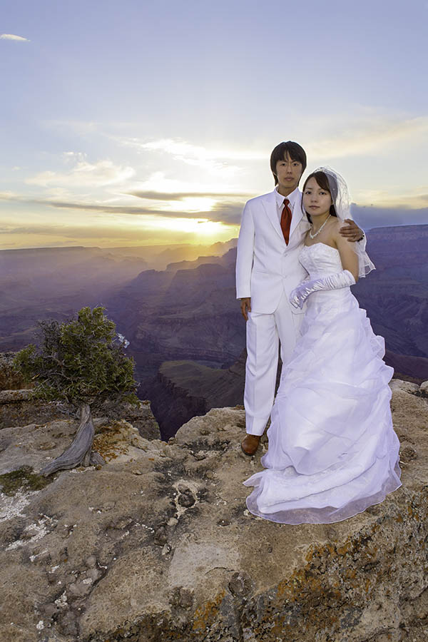 A Japanese Bride and Groom posing for wedding photos at Lipan point on the south rim of the Grand Canyon