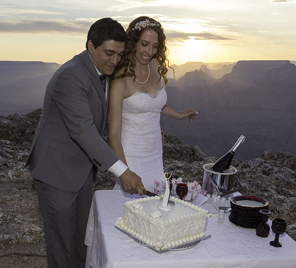 Bride and Groom cutting their wedding cake on the rim of the Grand Canyon