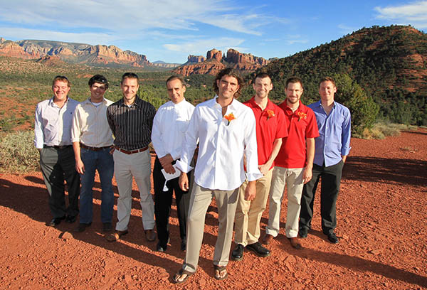 Groomsmen posing for a photo with the groom before his wedding which was outdoors in Sedona AZ