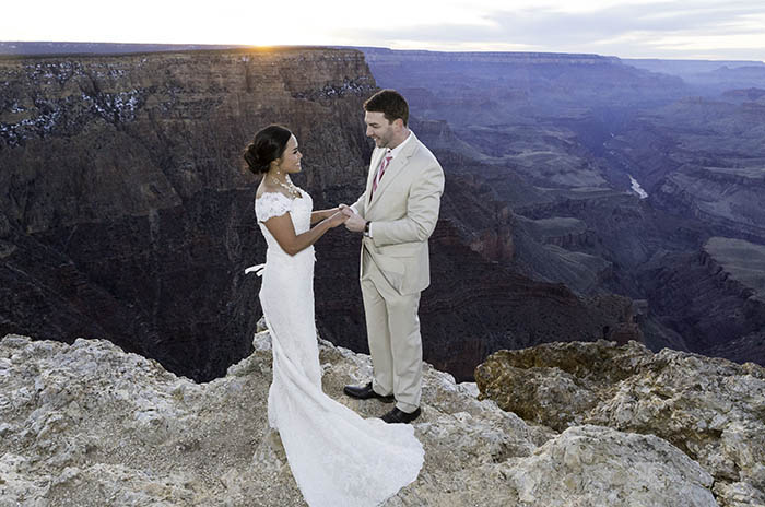 Newly married couple getting wedding photos taken at Lipan Point in the Grand Canyon