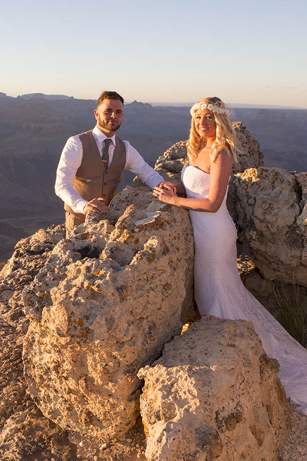 A picture of a couple who just eloped at the Grand Canyon, stainding on the edge