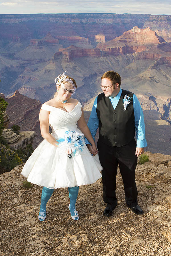 wedding couple holding hands on the South Rim of the Grand Canyon at Shoshone Point