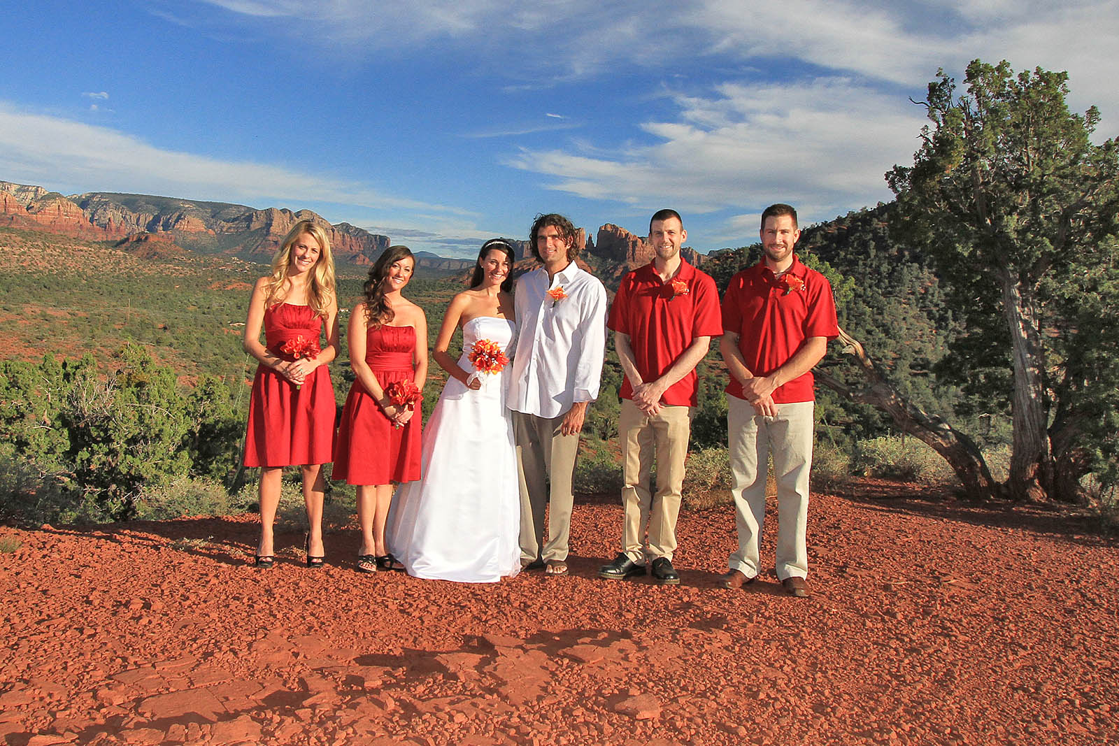 Wedding party posing for a picture outdoors in Sedona Arizona