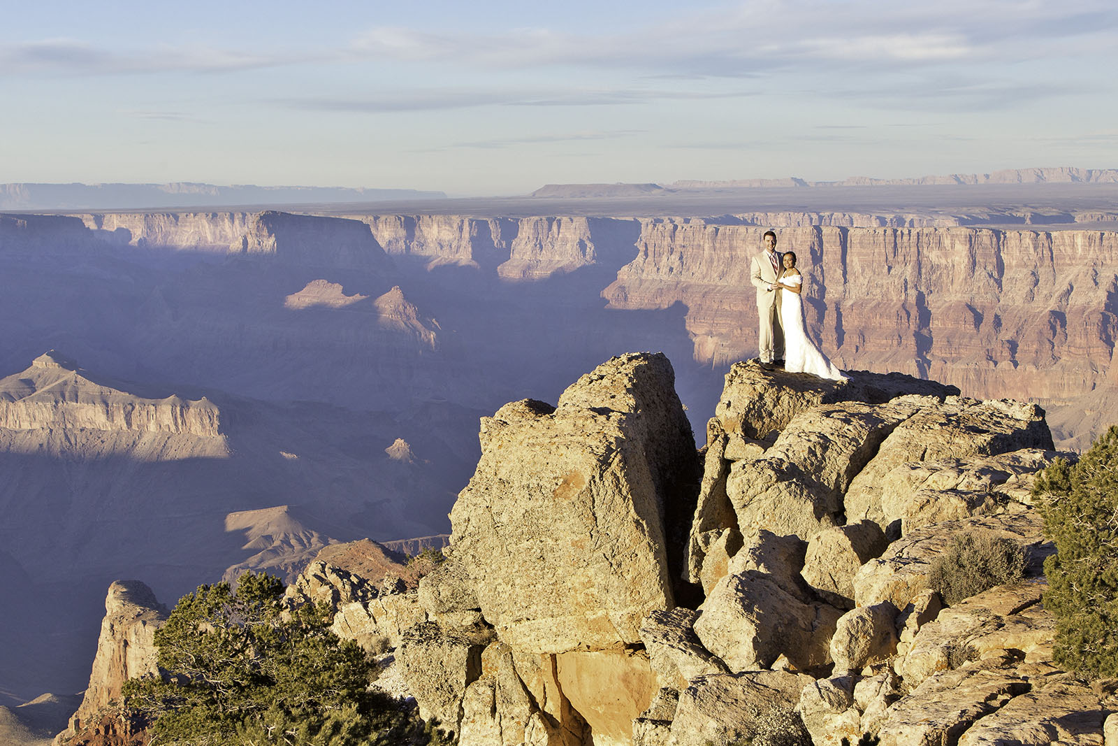 An American Groom and a Thai Bride having their wedding pictures taken at the Grand Canyon, Arizona